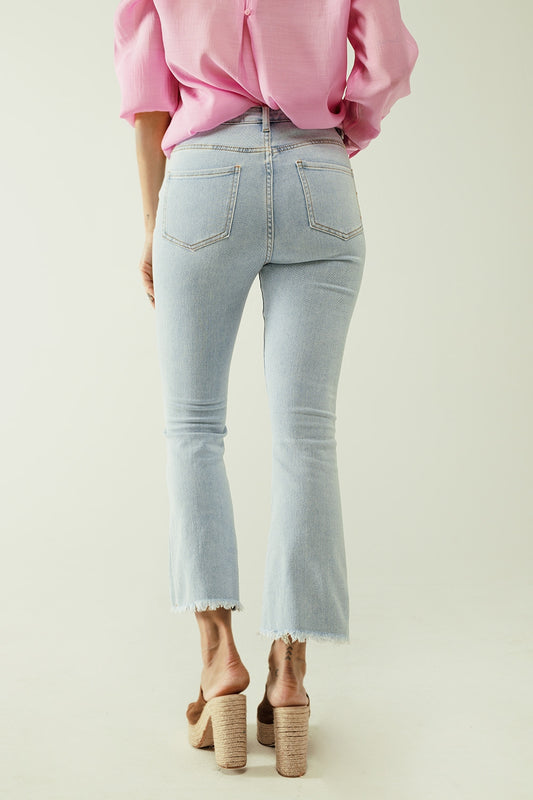 Flared light blue jeans with five pockets and seamless finish