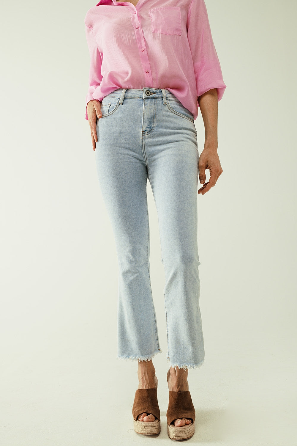 Flared light blue jeans with five pockets and seamless finish