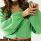 Green blouse with balloon sleeves and frontal closure with buttons