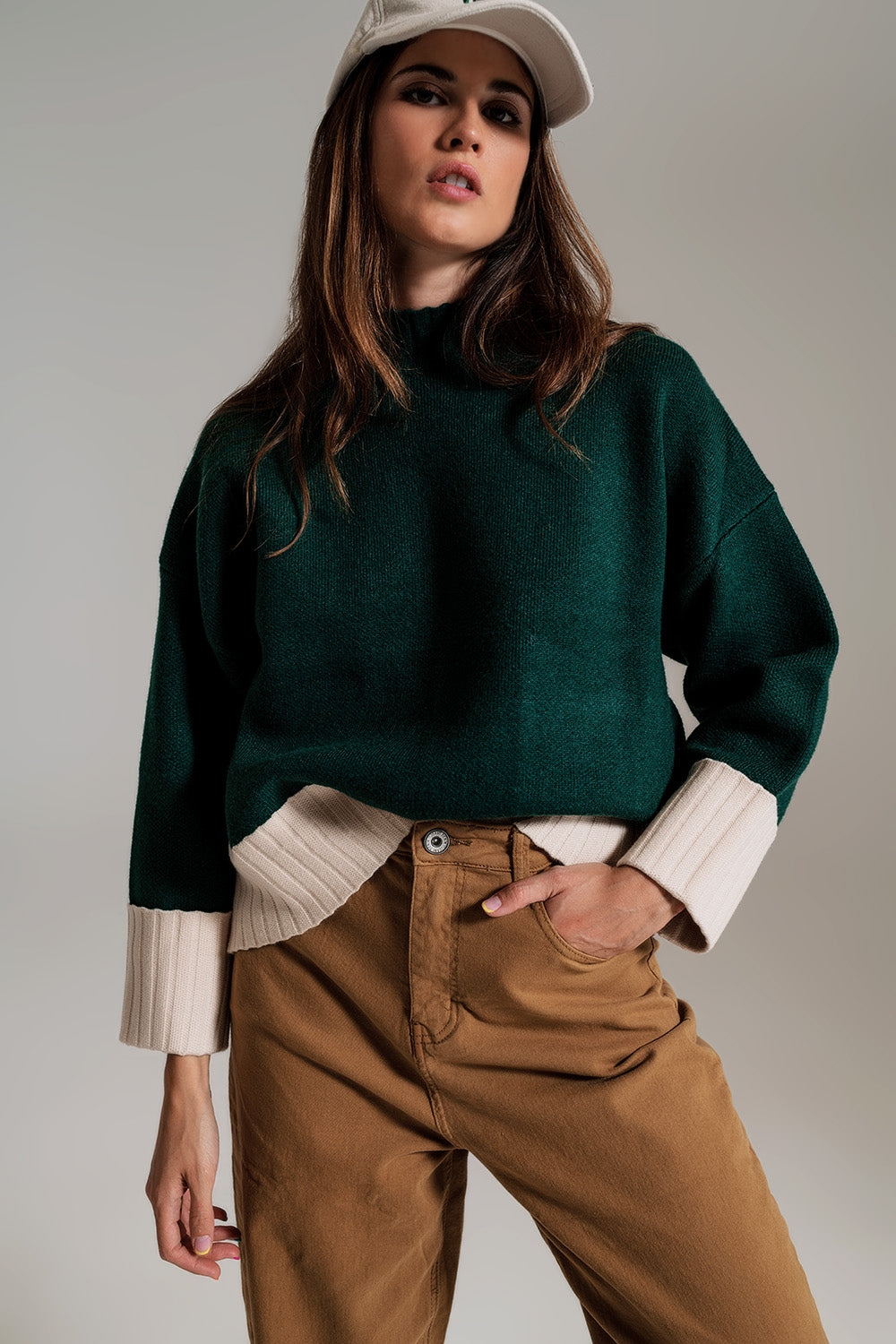 Q2 green jumper with white ribbed cuffs and hem
