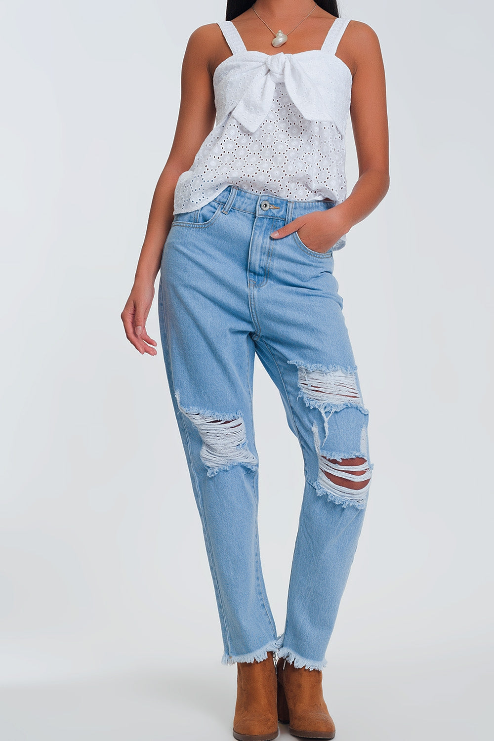 High waist mom jeans with busted knees in light denim