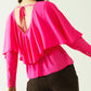 Ruffled V-neck top with buttoned cuffs and tie in the back detal in fuchsia