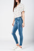 Skinny jeans in midwash with busted knees and chewed hems Szua Store