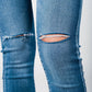 Skinny jeans in midwash with busted knees and chewed hems Szua Store