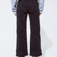Straight leg jeans in black with folded trouser legs