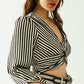 Striped crop top with V-neckline and twisted front in black and white.