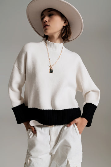 Q2 white jumper with black ribbed cuffs and hem
