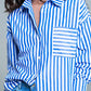 White oversized blouse with vertical stripes in blue and chest pocket