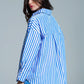 White oversized blouse with vertical stripes in blue and chest pocket